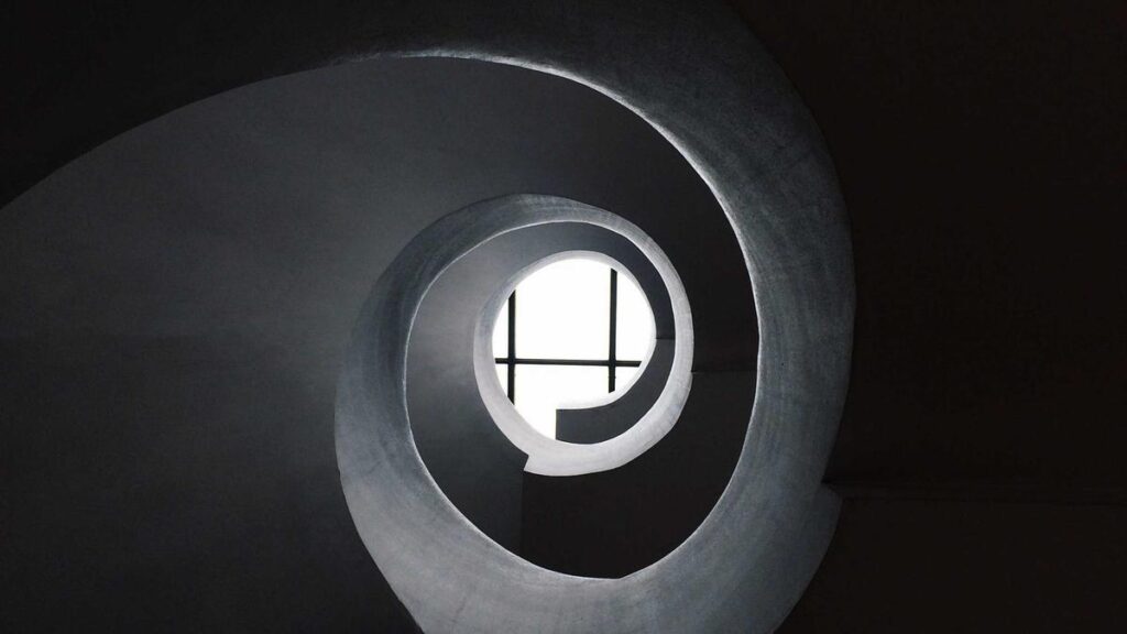 Designer arranging everyday objects into a playful construction